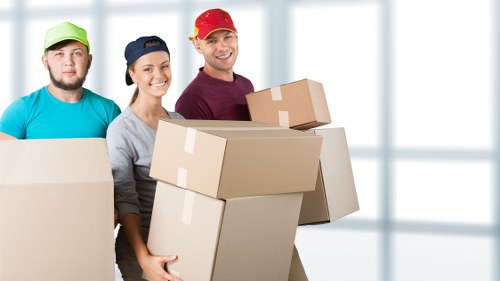 Unpacking service set up in a new home with boxes being placed by room