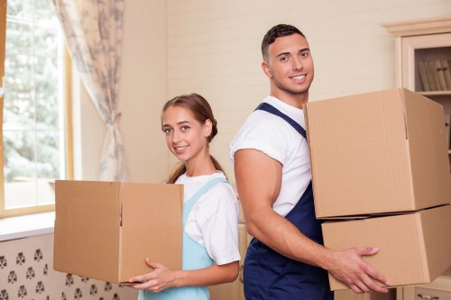 Local removals team handling furniture in an Eastcote street